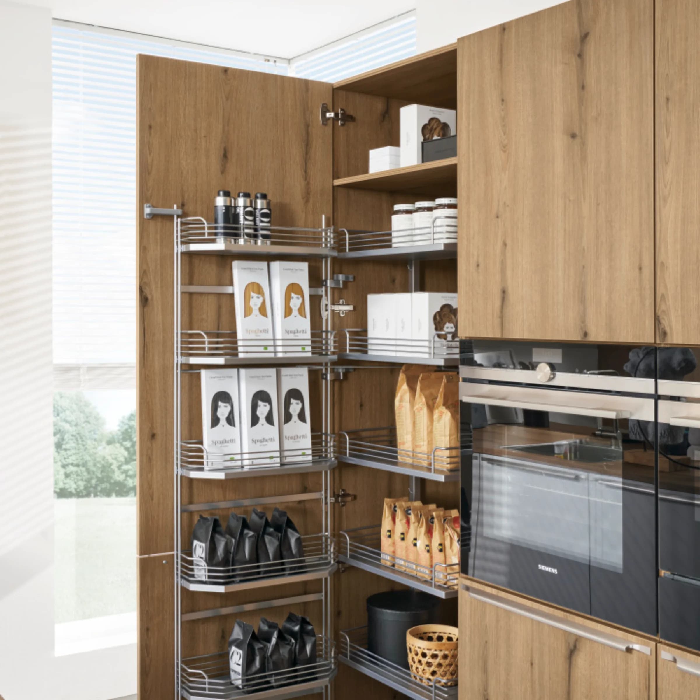 An open kitchen cabinet with supplies and a wood finish from Nolte Kitchen.
